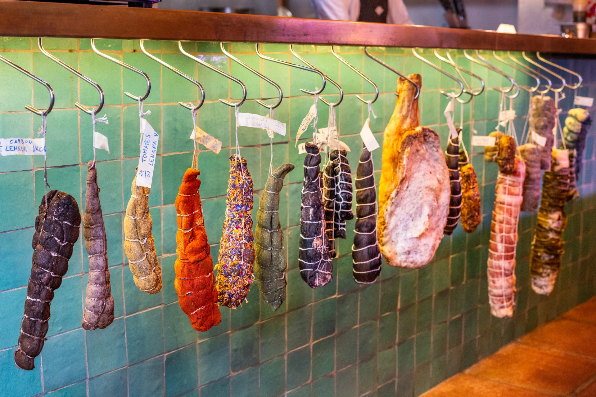 Cured meats hanging beneath the Cascada bar counter